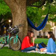 students talking next to a bike