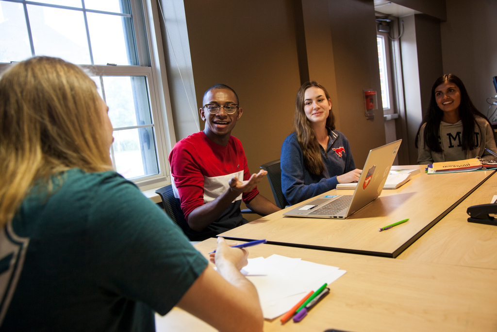 Students in class discuss a topic with one another